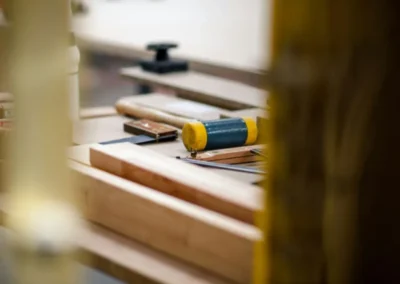 Inside Peter’s custom woodworking shop showing raw lumber and precision tools used for bespoke door and window modifications in castlegar bc.